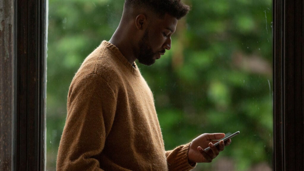 A man reading messages on his phone